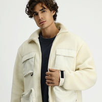 Off-white plush sweatshirt with zippered pockets.