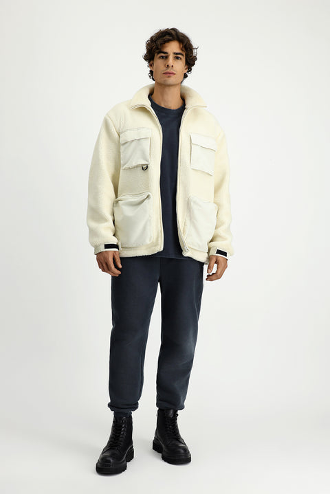 Off-white plush sweatshirt with zippered pockets.