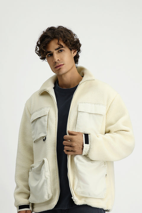 Off-white plush sweatshirt with zippered pockets.