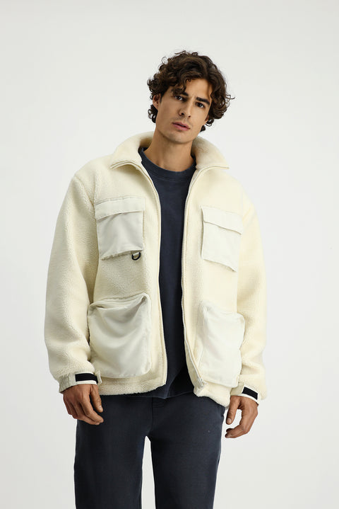 Off-white plush sweatshirt with zippered pockets.